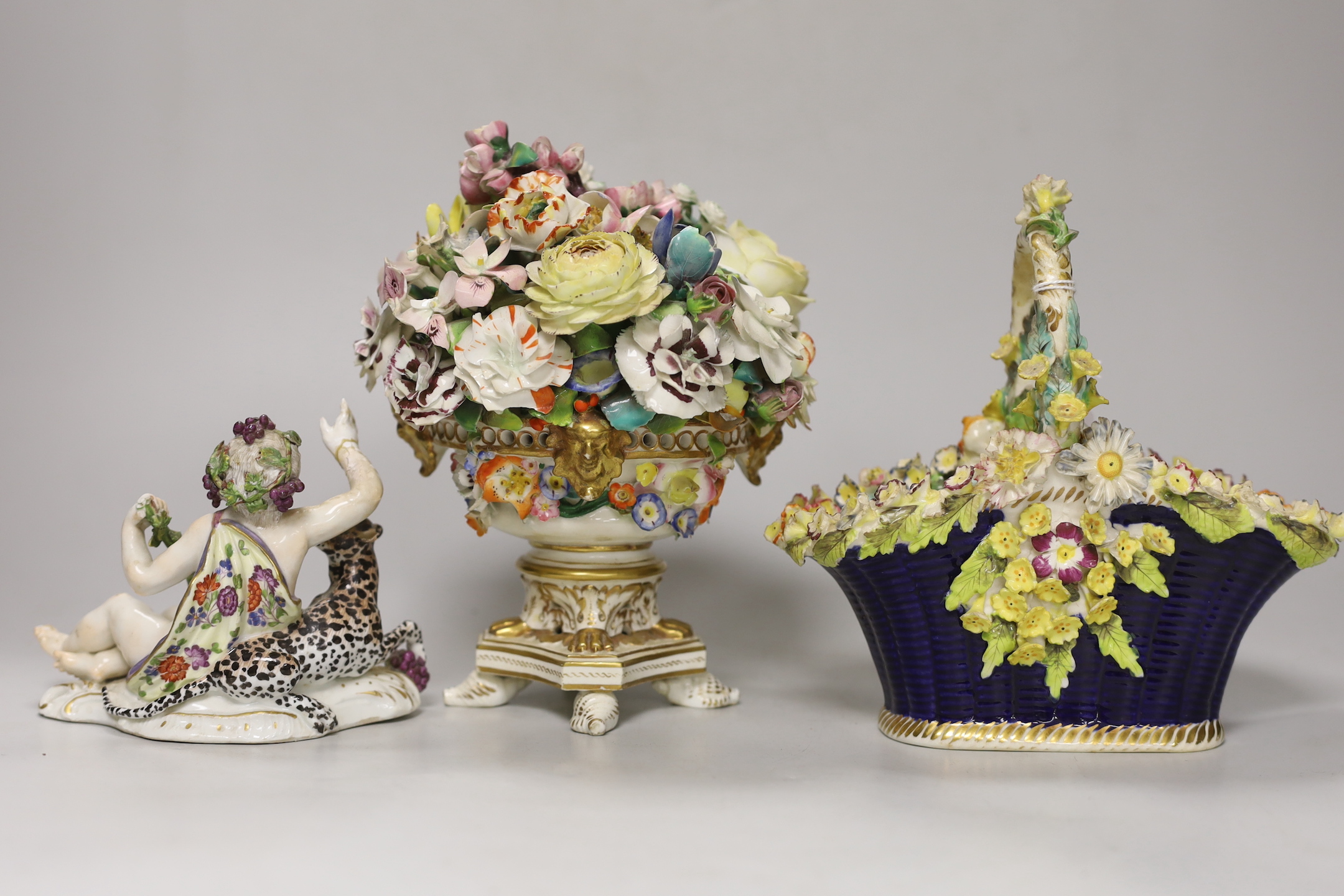 A Rockingham style floral encrusted basket, a Dresden floral centrepiece and a Meissen putti and leopard (a.f.), centrepiece 19cm high